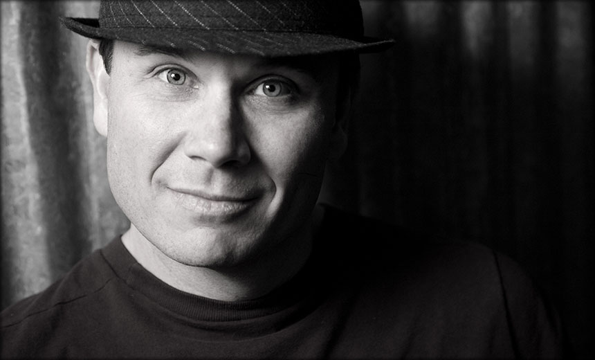 Closeup headshot of man in a fedora hat