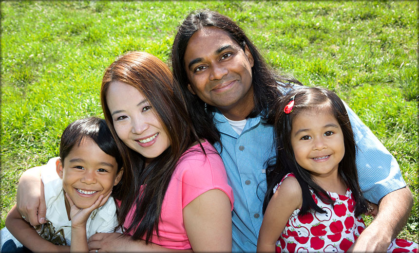 Cute family of four in a field