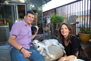 husband and wife with their three dogs at home