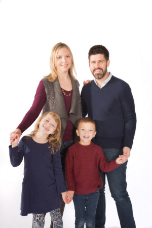 Family of four on white in studio