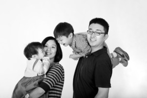 Playful asian family in studio black and white