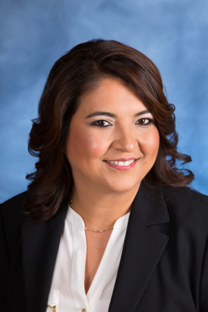 Headshot on woman with mottled blue background
