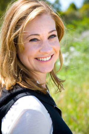 Bright over the should headshot of smiling girl