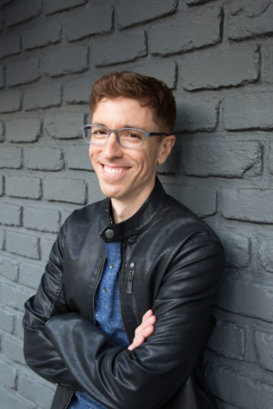 Grinning pose on gray brick wall