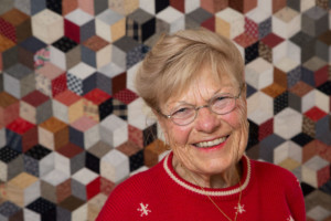 Grandma smiling with quilt background