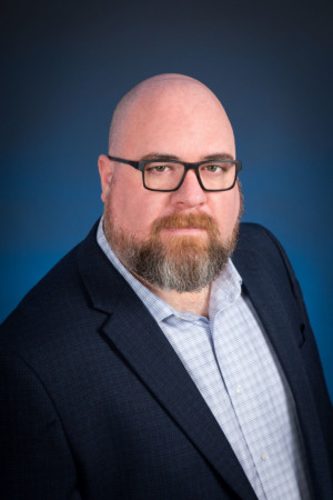 Studio headshot on blue