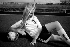 Soccer player in front of goal in black and white