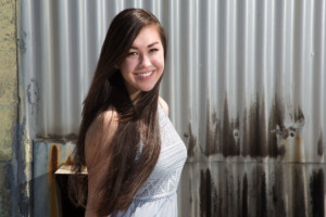 Smiling midrange girl on corrugated iron