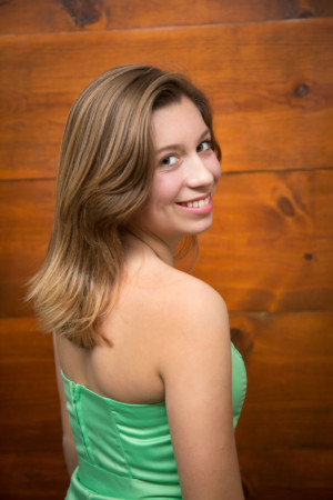 Over the shoulder smile on wood