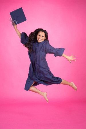 Jump shot Graduation Portrait on pink
