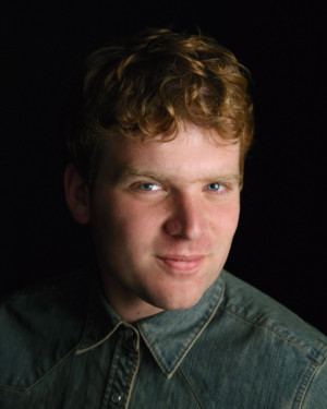 Moodily lit headshot senior