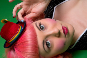 Closeup of clown inspired girl with tiny hat