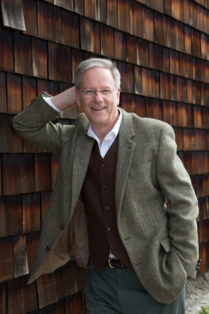 older gentleman in tweeds on a cedar shingle background