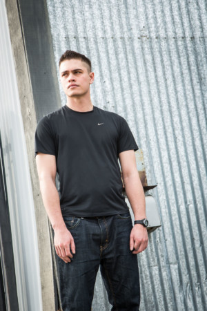 Edgy Aspiring male model on corrugated iron