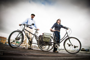 Couple stands proudly with their bikes