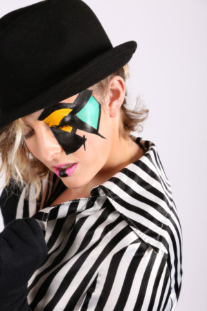 Clockwork orange style makeup on model with a hat