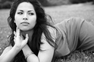 BW photo of girl laying in field