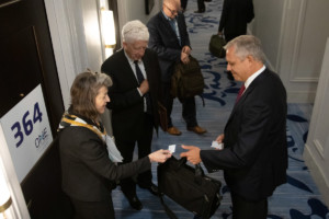 Woman passes business card at a conference